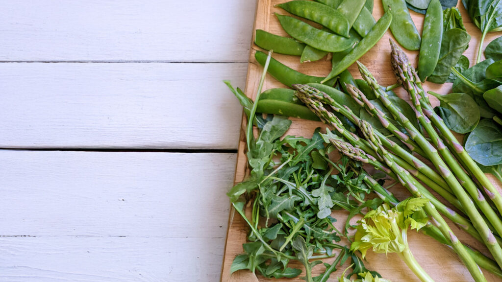 Spring vegetables on a white wood background